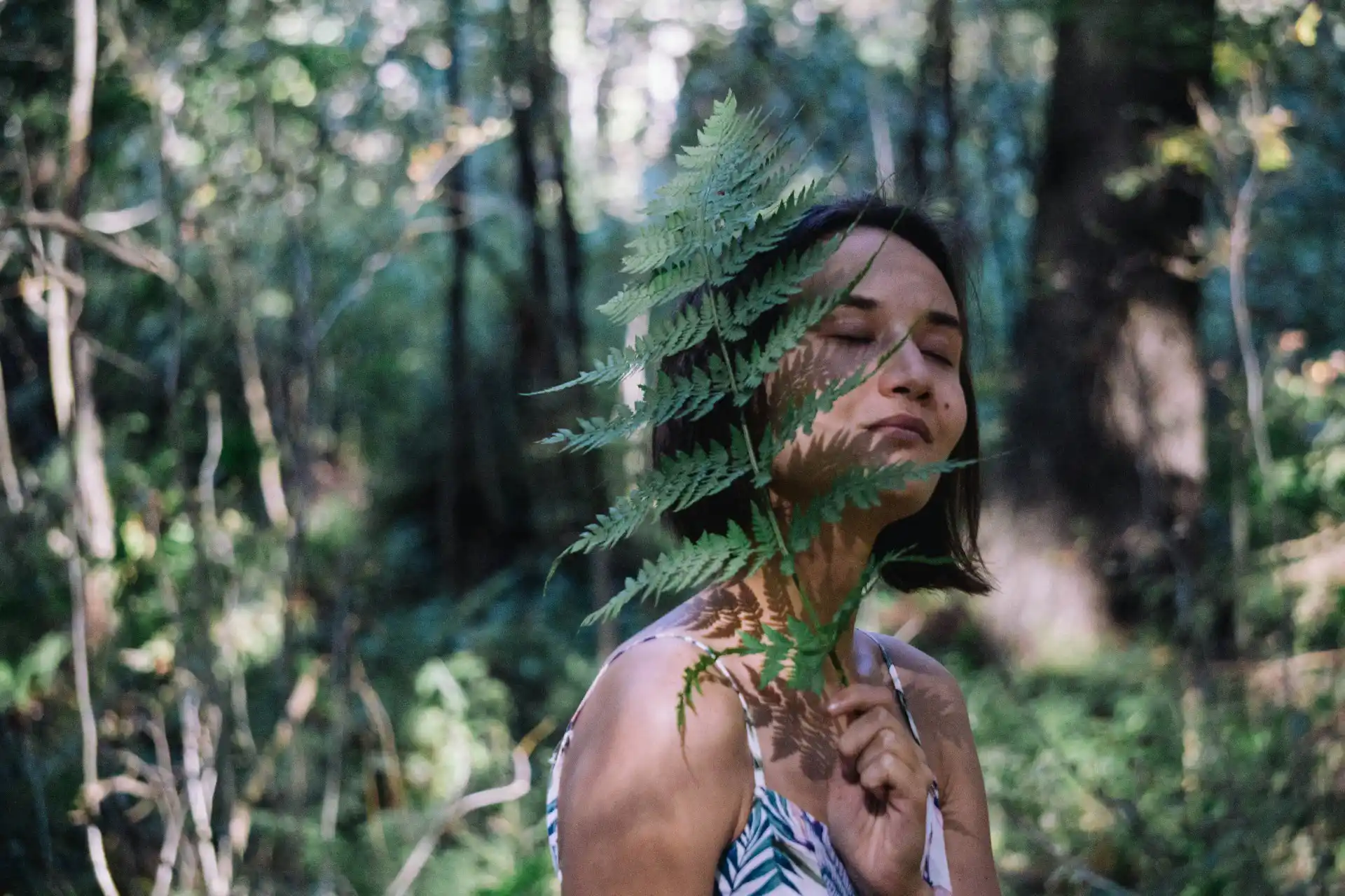 Frau in Natur mit geschlossenen Augen und mit sich verbunden